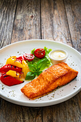 Wall Mural - Seared salmon steak with grilled bell pepper and mayonnaise on wooden table
