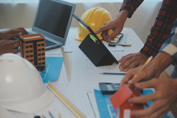 Construction and structure concept of Engineer or architect meeting for project working with partner and engineering tools on model building and blueprint in working site, contract for both companies.