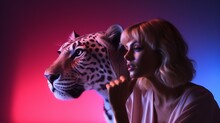 Beautiful Young Woman With A Fierce Leopard Under Pink And Blue Neon Light In Studio, Concept Of Dangerous, Woman Power And Fatal Temptation.
