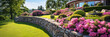 Landscape design of home garden with retaining wall, panoramic banner