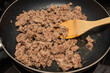 Cooking ground turkey meat in frying pan for a meal prep