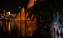 Landmark Stone Arch Bridge Showing The Arches And Graffiti At Night 