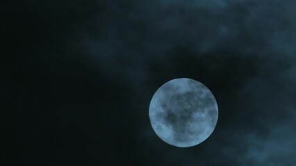 Wall Mural - full moon floating in the night cloudy sky. close-up. clouds at full moon. place to insert text. a s