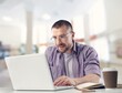 © BillionPhotos.com - Young busy business man working on laptop at office.