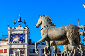 Wall Mural - Horses of Saint Mark, also known as the Triumphal Quadriga or Horses of the Hippodrome of Constantinople, and Clock Tower at San Marco Square in Venice, Italy