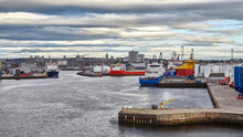 Panoramic View Of Aberdeen Port, During Working Day With Vessels Moored In Port, Cloudy Sky.