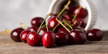Ripe And Juicy Cherries On The Dark Rustic Background. Selective Focus. Shallow Depth Of Field.
