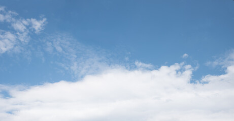 Wall Mural - blue sky background with copy space and white band of clouds below