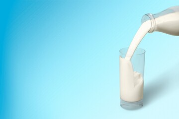 Canvas Print - Pouring fresh tasty milk in glass