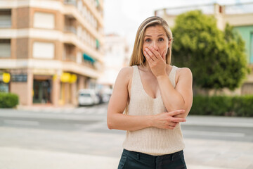 Wall Mural - Young blonde woman at outdoors surprised and shocked while looking right