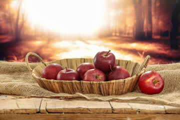 Poster - Fresh apples on table and autumn landscape. 