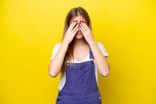 Young Caucasian Woman Isolated On Yellow Background Covering Eyes By Hands