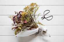 Bouquet Of Dried Flowers Lying On White Painted Wood
