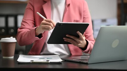 Wall Mural - bussinesswoman analyzing sales data and economic growth and pointing at business report document wit