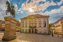 Germany, Rhineland-Palatinate, Landau, Sun Setting Over Town Hall With Equestrian Statue In Foreground