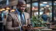 © carballo - african american businessman with mobile phone