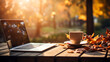 © Tech Hendra - Laptop and cup of coffee on wooden table with autumn background.