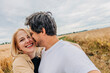 © Westend61 - Smiling couple hugging in wheat field