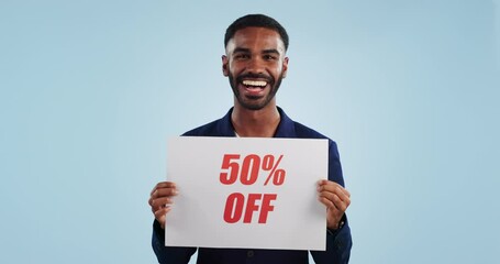 Wall Mural - Discount price sign, man and wow face from shopping deal, promotion and poster in studio. Happy, excited portrait and smile with sale announcement promo on paper for advertising with blue background