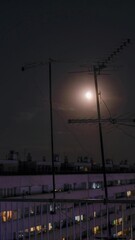 Wall Mural - time lapse of the city tv antennas and the  moon over the cloudy sky