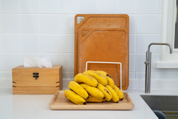 A bunch of fresh banana in a modern kitchen.