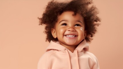 Wall Mural - An innocent smile from an African American toddler against a light beige background.