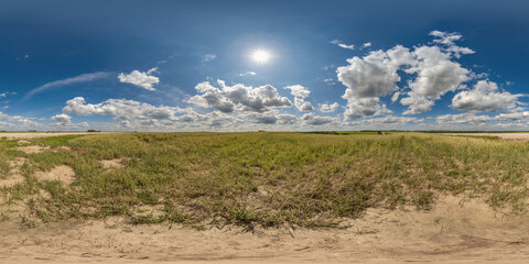Wall Mural - spherical 360 hdri panorama among dry grass farming field with clouds on blue sky in equirectangular