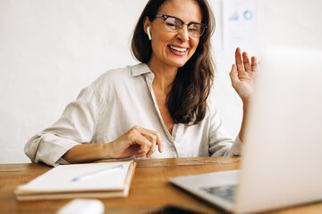 Wall Mural - Business woman engaging in an online meeting using a laptop