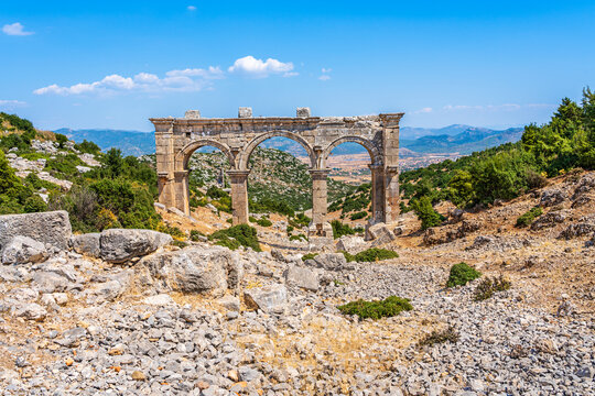 Ruins of Ariassos Ancient City in the Antalya Province of Turkey; archeologic arch at Hellenistic period town built on a steep hillside in Pisidia, Asia Minor