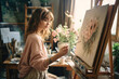 © GVS - Young female artist painting on canvas in studio.