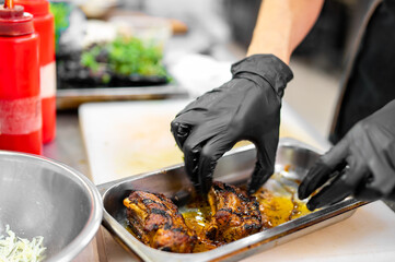 Wall Mural - woman chef hand cooking pork ribs in kitchen