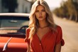 Hot sexy young woman near a 60-70s style retro car in sunglasses and a summer dress with a low neckline