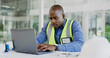 © Anela R/peopleimages.com - Man, engineering and laptop for online planning, blueprint report and design update in office project management. African builder, contractor or architecture worker typing on computer for floor plan