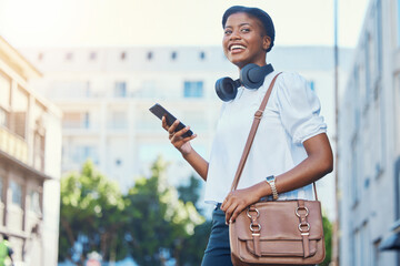 Fototapete - Phone, walking and young woman in the city networking on social media, mobile app or the internet. Happy, technology and African female person scroll on cellphone and commuting in urban town street.