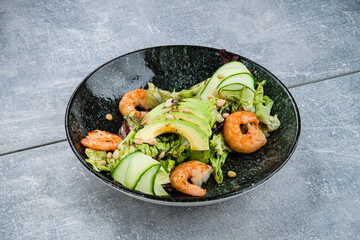 Canvas Print - Fresh salad with shrimp, avocado, lettuce, cucumber and pine nuts.