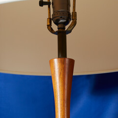 Vintage stylish white lamp. Interior product photograph with a blue background.