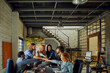 © Geber86 - Young and diverse group of designers having a meeting in an office while working in a startup company
