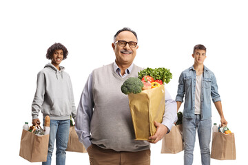 Sticker - Smiling mature man standing in front of young men with grocery bags