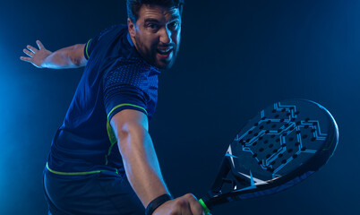 Padel Tennis Player with Racket in Hand. Paddle tenis, on a blue background. Download in high resolution.