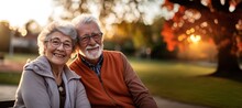 Woman Man Senior Couple Happy Retirement Together Elderly Hug Active Bonding Park Outdoor Sitting Bench Leisure Fun Smiling Love Old Nature Wife Happiness Mature