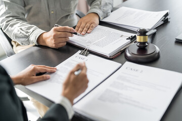 Wall Mural - Lawyer Legal counsel presents to the client a signed contract with gavel and legal law. justice and lawyer Business partnership meeting concept