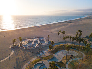 Wall Mural - Aerial photos of the Venice Beach Skate Park taken with a drone during sunset. Long shadows of palm trees and skateboarders.