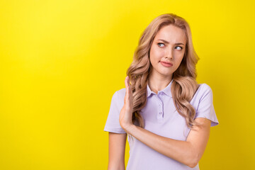 Sticker - Photo of serious unsure woman dressed violet t-shirt showing arm palm no empty space isolated yellow color background