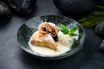 Wall Mural - Fried sweet thin pancakes with apples, raisins, ice cream and mint in a plate.