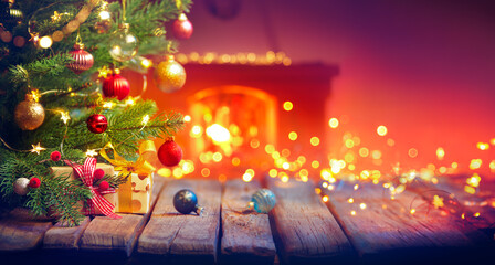 Wall Mural - gift under christmas tree with baubles in home interior with fireplace and abstract defocused lights