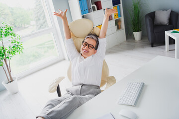 Poster - Photo of dreamy businesswoman gray hair experienced lawyer celebrate job done hands up lying office chair isolated daylight background