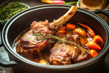 Mouth-watering Lamb Shoulder Roast With Apricots Carrots Onions And Thyme In Cast Dutch Oven. Traditional African Moroccan Cuisine Dish Specialty For Family Dinner Holiday Celebrations