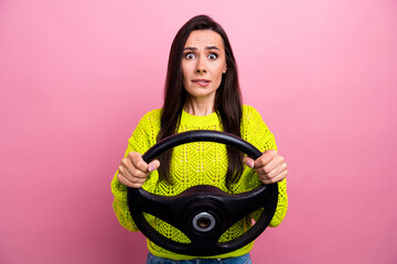 Sticker - Photo of speechless girl with brunette hair dressed yellow sweater biting lips hold streering wheel isolated on pink color background