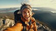A man capturing his adventurous spirit with a selfie atop a majestic mountain peak