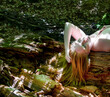 © ullision - sensual portrait of young beautiful sexy naked redhead woman lying on a fallen tree trunk in the sunny forest, her long red hair hanging down